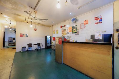 a restaurant with a counter and chairs in a room at RedDoorz at Taman Galaxy Bekasi in Bekasi