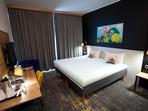 a hotel room with a bed and a desk at ibis styles Grudziadz in Grudziądz