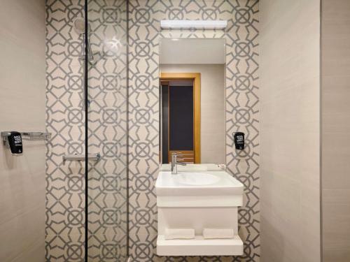 a bathroom with a sink and a mirror at ibis Styles Manama Diplomatic Area in Manama