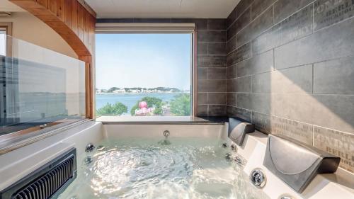 a jacuzzi tub in a room with a large window at Daebudo (Yeongheungdo) Dunia Spa Pension in Incheon