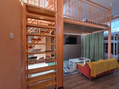 a room with a loft bed and a living room at Danista Nomads Tour Hostel in Ulaanbaatar
