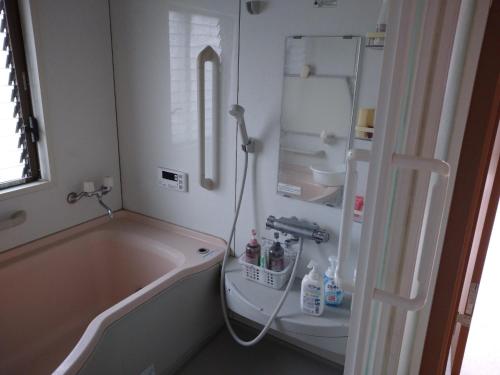 a bathroom with a tub and a toilet and a sink at Hall D - Vacation STAY 14820 in Kōnosu
