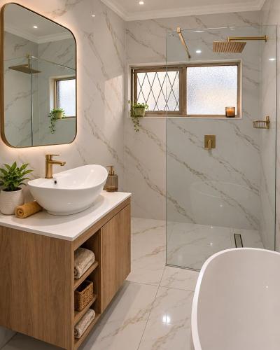 a bathroom with a sink and a mirror at The Luxury Orchid in Pietermaritzburg