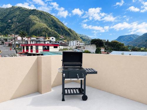 a laptop computer sitting on a table on a balcony at Luxury Penthouse with Jacuzzy 6 bedroom in Baños