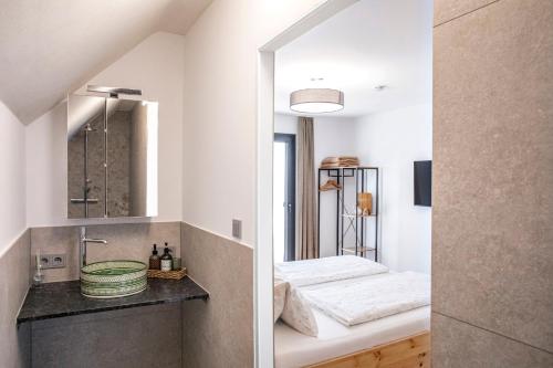 a bathroom with two sinks and a mirror at Weingut Peter Grill in Leutschach