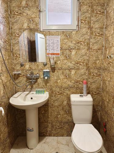 a bathroom with a toilet and a sink at Hotel Jacob in Ureki