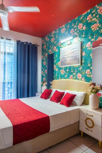 a bedroom with a large bed with floral wallpaper at Nziwa's Paradise Bamburi in Mombasa
