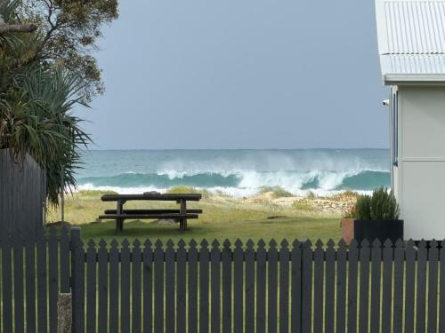a wooden picnic table in front of the ocean at Family & Couples Beachside Stay Ocean Glimpses 7 day Xmas 2026 available in Brooms Head
