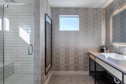 a bathroom with a sink and a shower at Bluestem Hotel Torrance Los Angeles, an Ascend Collection Hotel in Torrance