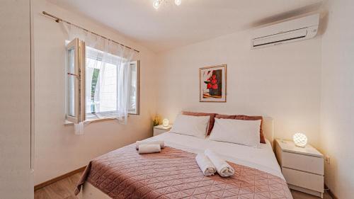 a bedroom with a bed with two towels on it at Villa Toma by Villas Guide in Orebić