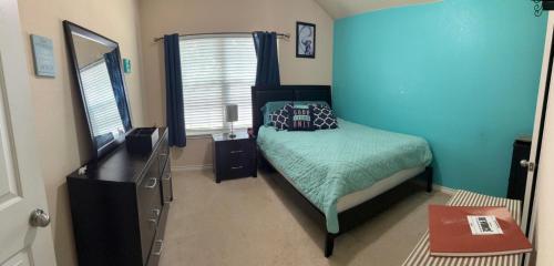 a bedroom with a bed with a blue wall at Trunks up! Spacious home ready for a fun time! in Lancaster