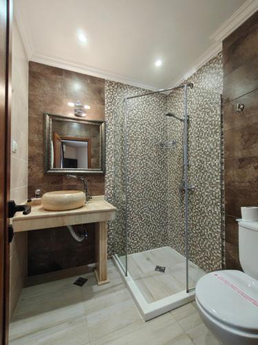 a bathroom with a shower and a sink and a toilet at Семеен хотел"Свети Георги" in Burgas