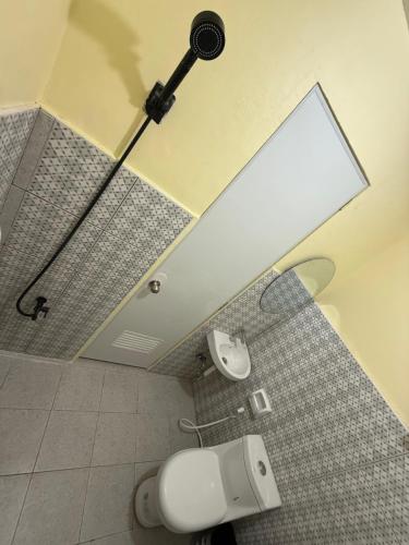 a bathroom with a shower with a light on the ceiling at Homestay de Baclayon in Baclayon