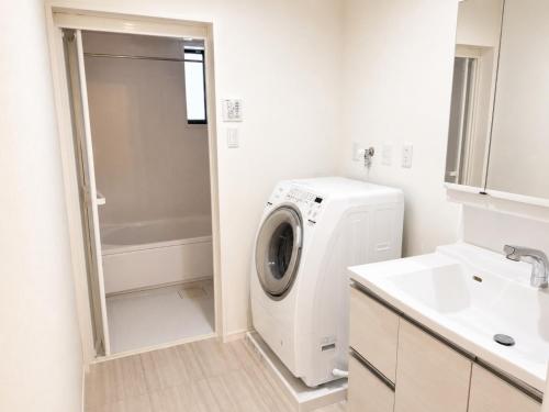 a white washer and dryer in a bathroom at Nakijin Terrace in Nakijin
