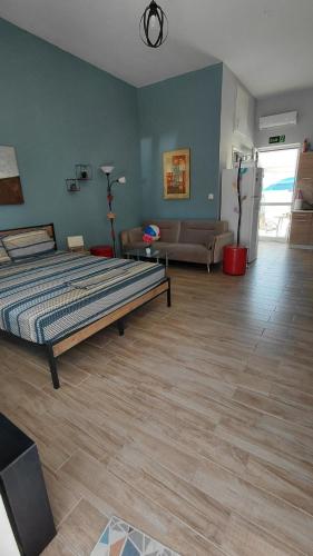 a bedroom with a bed and a living room at Victoria's dream in Filiatra