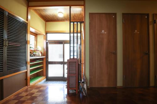 a room with a hallway with wooden floors and a door at DON chan GuestHouse Nikko ,7 minutes walk from Imaichi Station in Nikko