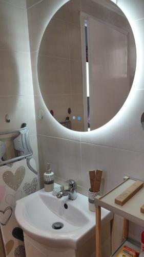 a bathroom with a sink and a mirror at Victoria's dream in Filiatra