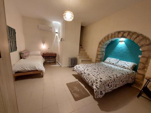 a bedroom with a bed and a stair case at The Essence in Safed