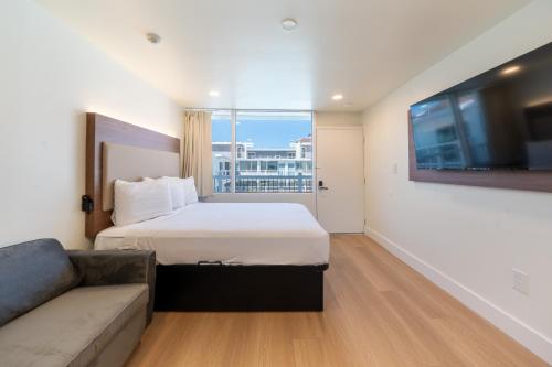 a hotel room with a bed and a couch at Ocean's Edge Luxury Rentals in Ocean City