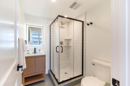 a bathroom with a shower with a toilet and a sink at Ocean's Edge Luxury Rentals in Ocean City