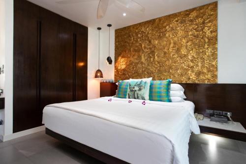 a large white bed in a room with a wall at Karon Beach Stunning 2 bed apt unit 700 in Karon Beach