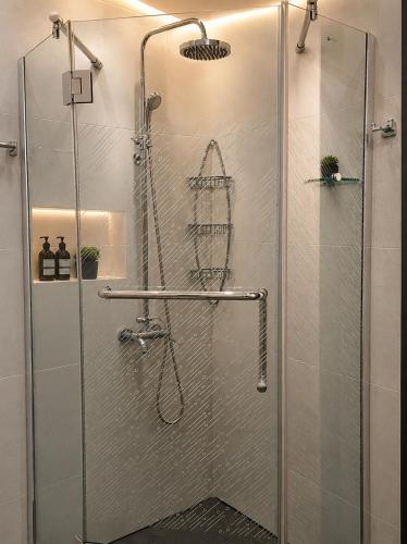 a shower with a glass door in a bathroom at Villa Kobuleti in Kobuleti