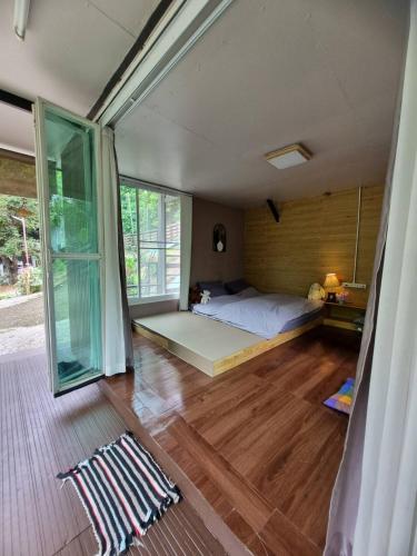 a bedroom with a bed and a large window at Rim Tarn Phu View Chiang Mai in Ban Khanin Tai