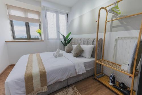 a bedroom with a bed with white sheets and pillows at Riveria City by Nomadnest in Kuala Lumpur