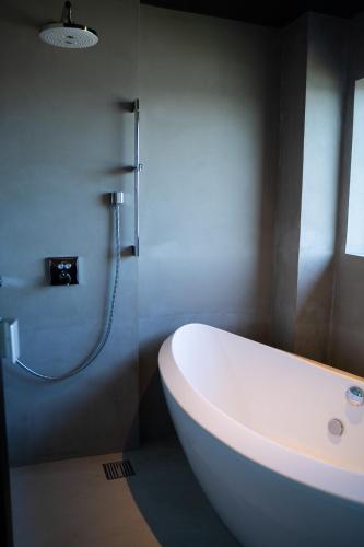 a bathroom with a white sink and a shower at Villa LUAR in Minamiawaji