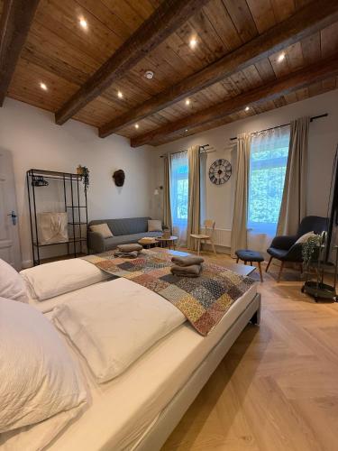 a large white bed in a room with a couch at Villa Manninga in Krummhörn