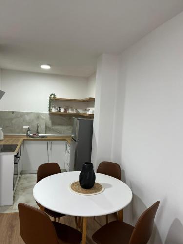 a white table and chairs in a kitchen at Apartman M&M in Teslić