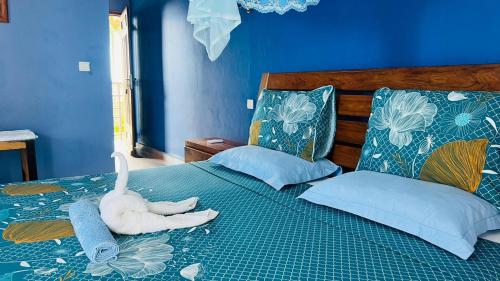 a bedroom with a stuffed swan laying on a bed at Nosy Bay View in Nosy Be