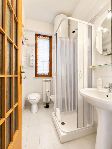 a bathroom with a shower and a toilet and a sink at Oasi Palma - Mondello in Palermo