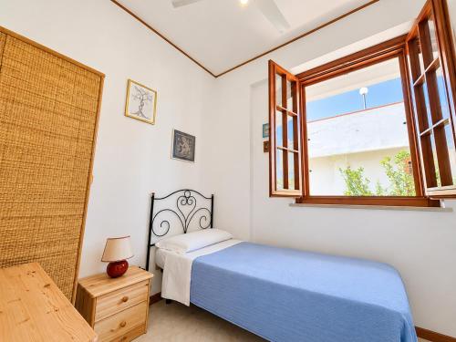 a bedroom with a bed and a window at Oasi Palma - Mondello in Palermo