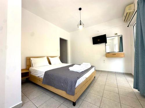 a bedroom with a bed and a television in it at Enjoy Parga Appartments in Parga