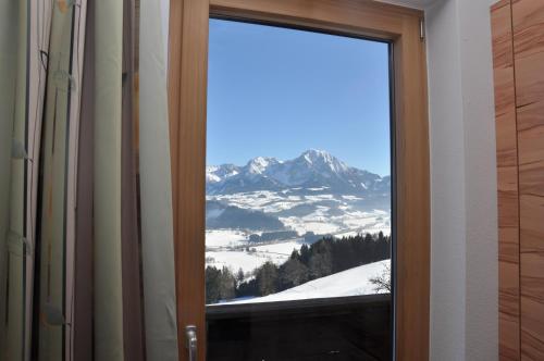 a sliding glass door with a view of a mountain at Ferienhof Berger in Rossleithen