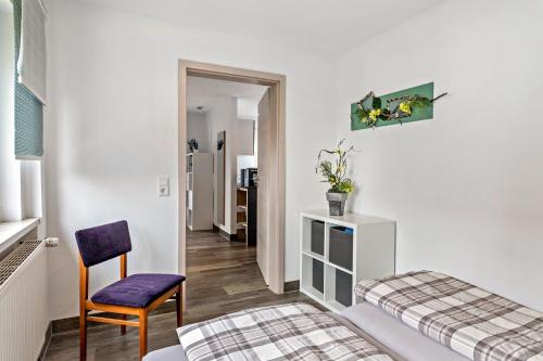a bedroom with a bed and a chair in a room at Fewo Drei Gleichen Nr 2 in Wandersleben
