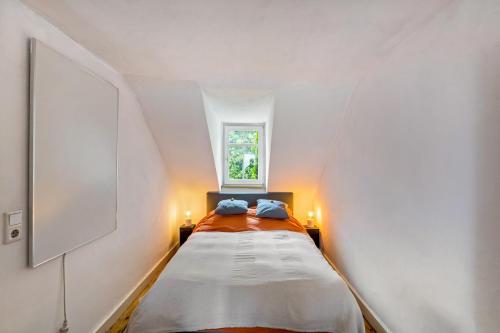 a small bedroom with a bed in a attic at Large Apartment 60 M² With Garden in Emmendingen