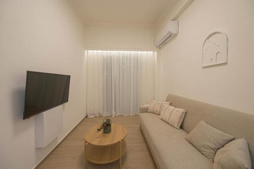 a living room with a couch and a table at Corali 1 - Coastal Retreat in Katakolo