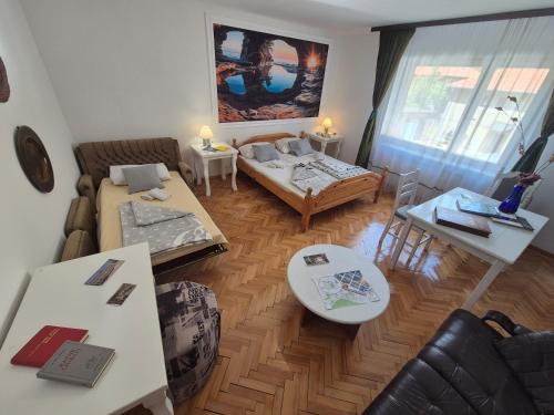 a living room with a couch and a table at Apartmani CARDAK in Paša Bunar