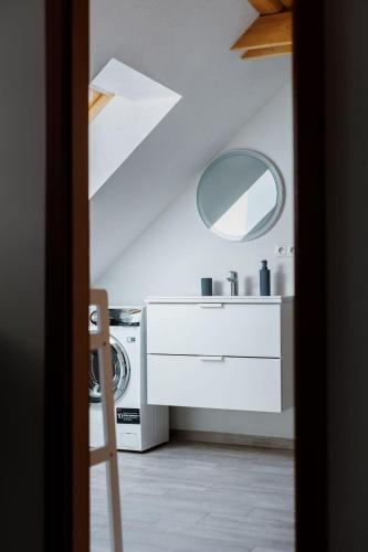 a bathroom with a washing machine and a mirror at Kralova Apartment in Modra in Modra