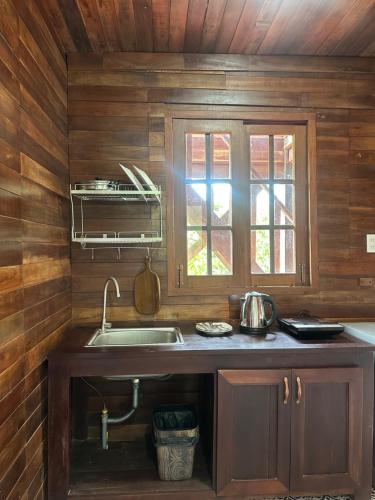 a kitchen with a sink and a window at MK Hill resort Phu Quoc in Phú Quốc