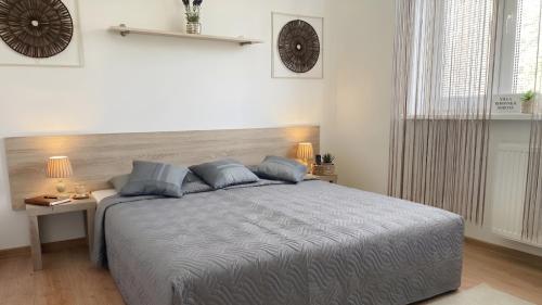 a bedroom with a large bed with blue pillows at Villasobota in Rimavská Sobota