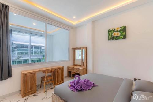 a living room with a couch and a window at Made's Dream Villa Amed in Amed