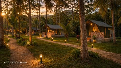 a resort with candles in the grass with palm trees at COCO FOREST CAMPING - Luxury Glamping & Villa - ONLY FOR FOREIGN BOOKINGS in Kurunegala