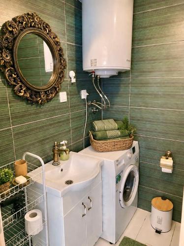 a bathroom with a washing machine and a sink at Stonehouse Kotor Bay in Kotor