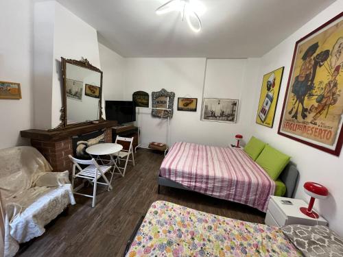 a room with two beds and a table in it at Room Saronno + B&B in Saronno