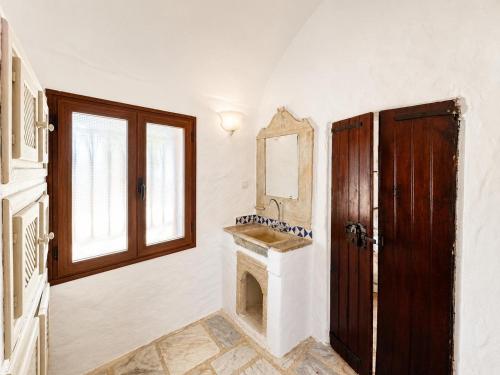 a room with a fireplace and a mirror and a door at Maisonnette Olea Hammamet in Hammamet