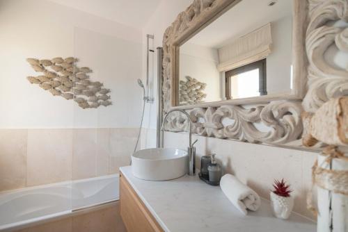 a bathroom with a sink and a mirror at La Villa in Illes Balears