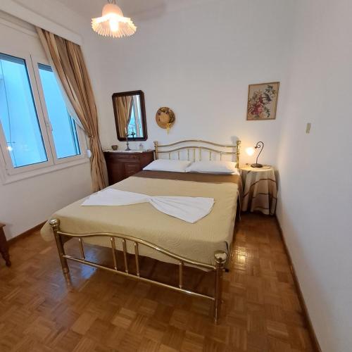 a bedroom with a bed and a large window at Chios Studios Kalamari in Vrontádos